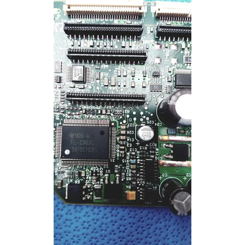 Green printed circuit board with black integrated circuits capacitors and connectors for c7769-60007 carriage pca board