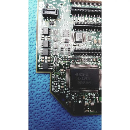 Green printed circuit board with black integrated circuits and silver solder points of c7769-60007 carriage pca board for hp designjet