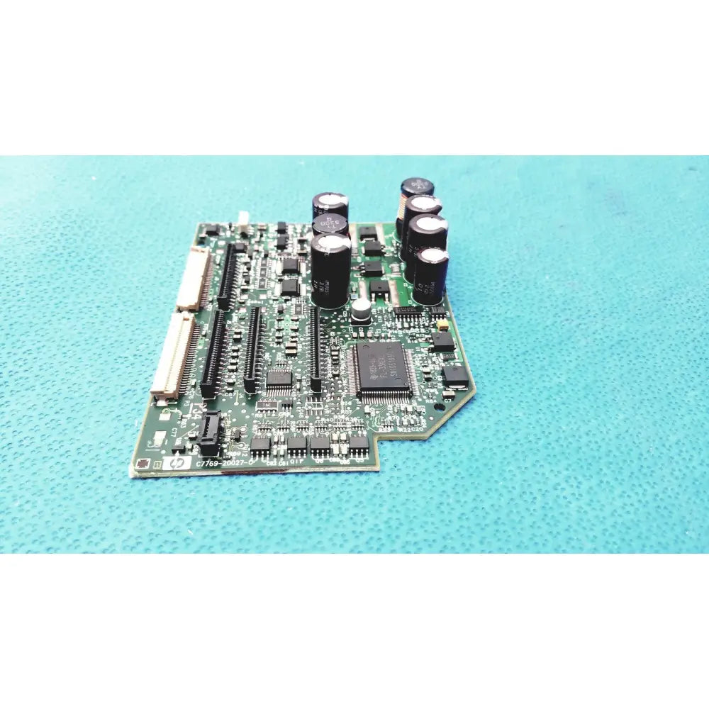 Green printed circuit board with black capacitors and integrated circuits for c7769-60007 carriage pca board
