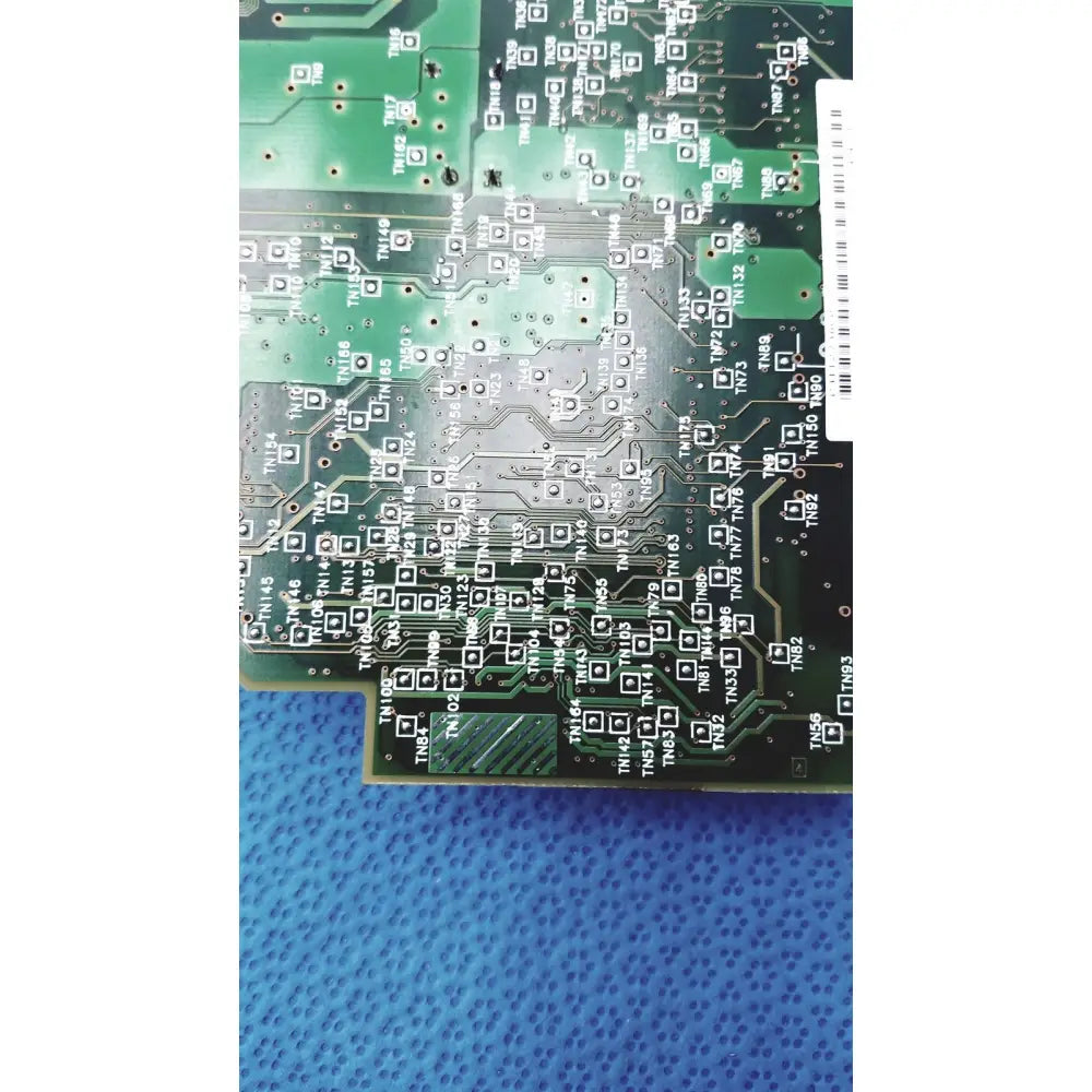 Green printed circuit board with silver soldered traces and labeled component footprints for c7769-60007 carriage pca board