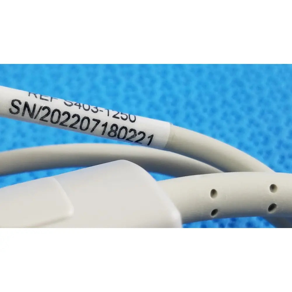 White cable of s403-1250 adult spo2 pulse oximeter sensor with label showing serial number and reference code
