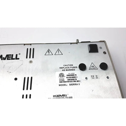 Silver metallic cadwell sierra ii wave channels base station power supply unit with black knobs and warning labels