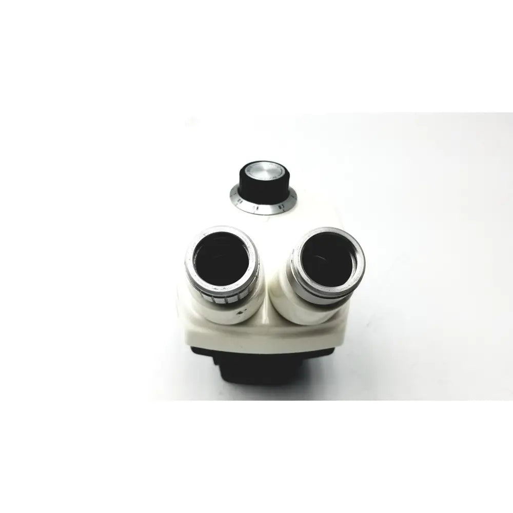White and black binocular microscope with silver-rimmed eyepieces and central focus knob for cambridge instruments stereozoom