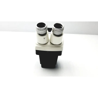 Black and white binoculars with silver-rimmed eyepieces from cambridge instruments stereozoom with zoom range 0.7x-3.0x