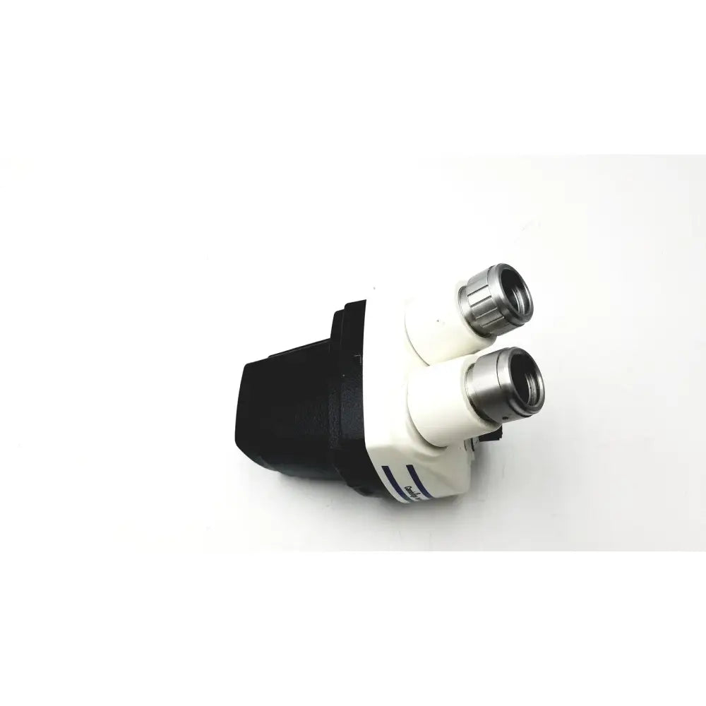 White and black cambridge instruments stereozoom 4 stereo microscope with metallic eyepieces and zoom range 0.7x-3.0x