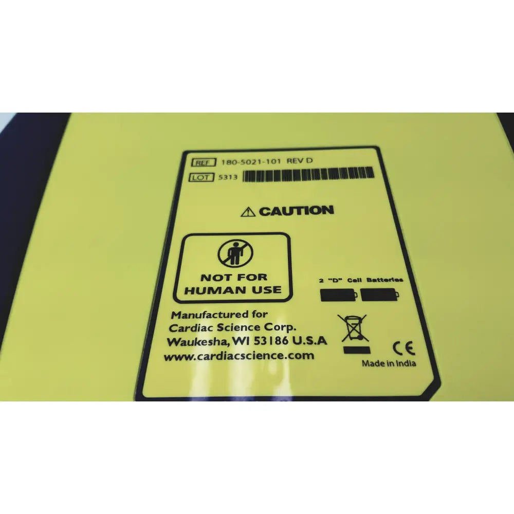 Yellow rectangular label with black text on cardiac science aed trainer teaching device indicating not for human use warning
