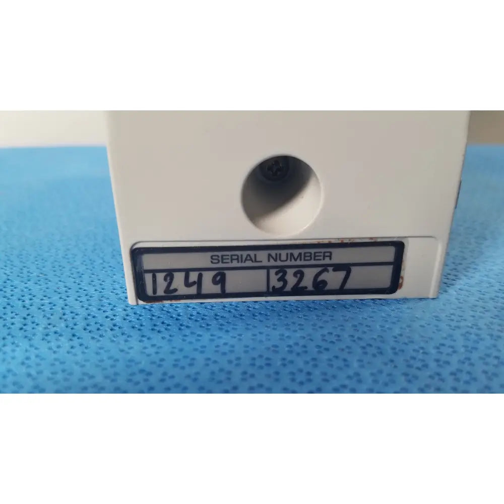 White plastic cardinal health alaris pump 8100 series device with serial number 12493267 visible on black label