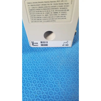 White plastic product label on the back of cardinal health alaris pump 8100 series with black text patent info and barcode