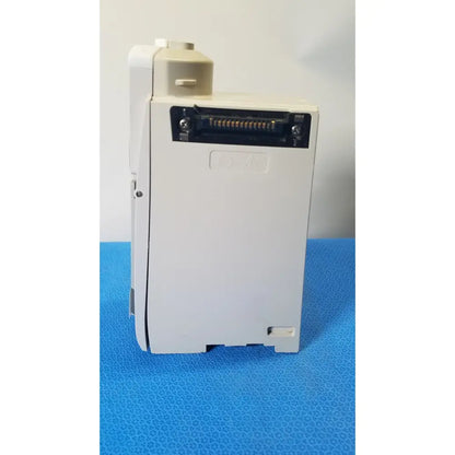 White plastic industrial control module with black connector port and embossed qa marking for cardinal health alaris pump 8100 series