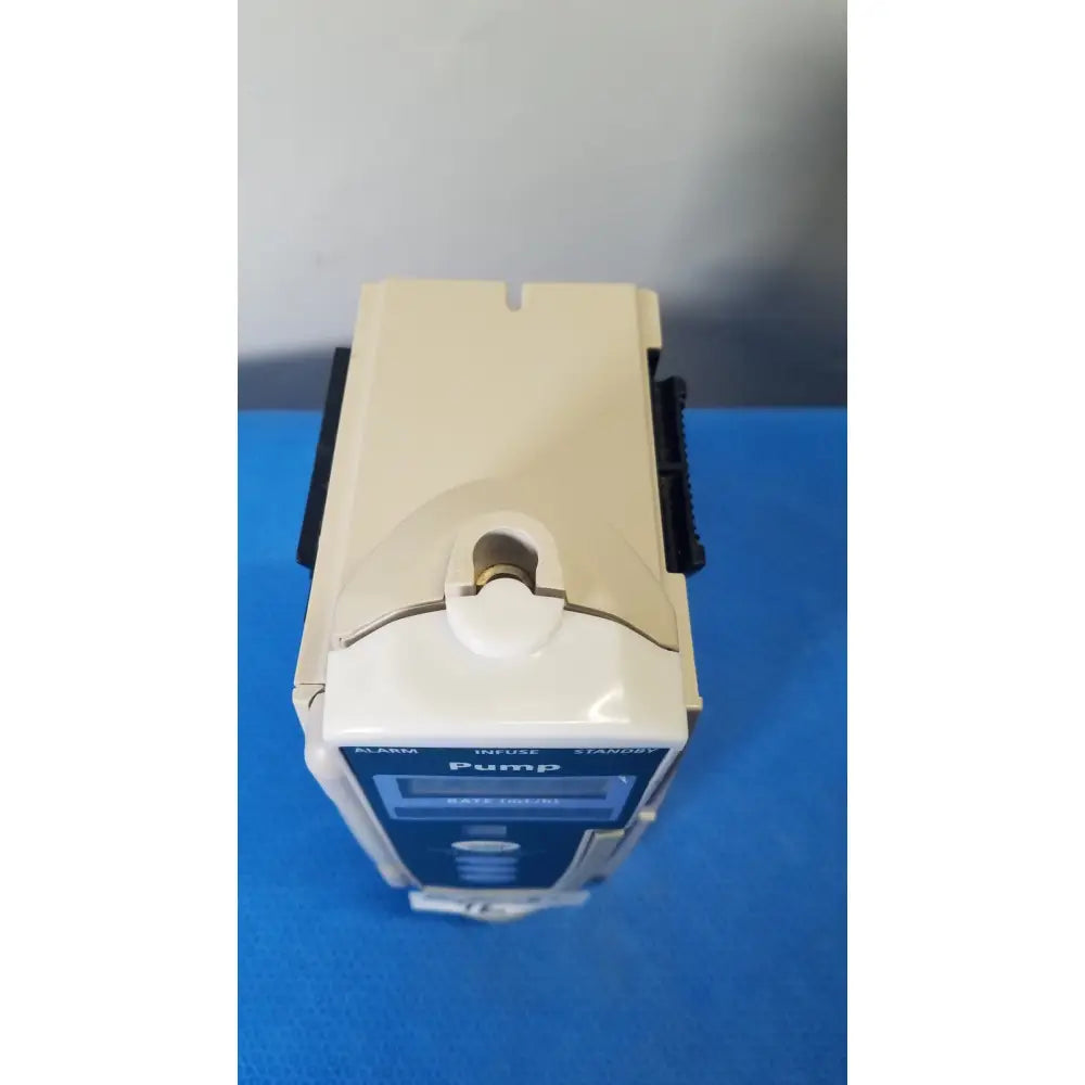 Beige and blue cardinal health alaris pump 8100 series medical infusion pump with digital display labeled pump on front panel