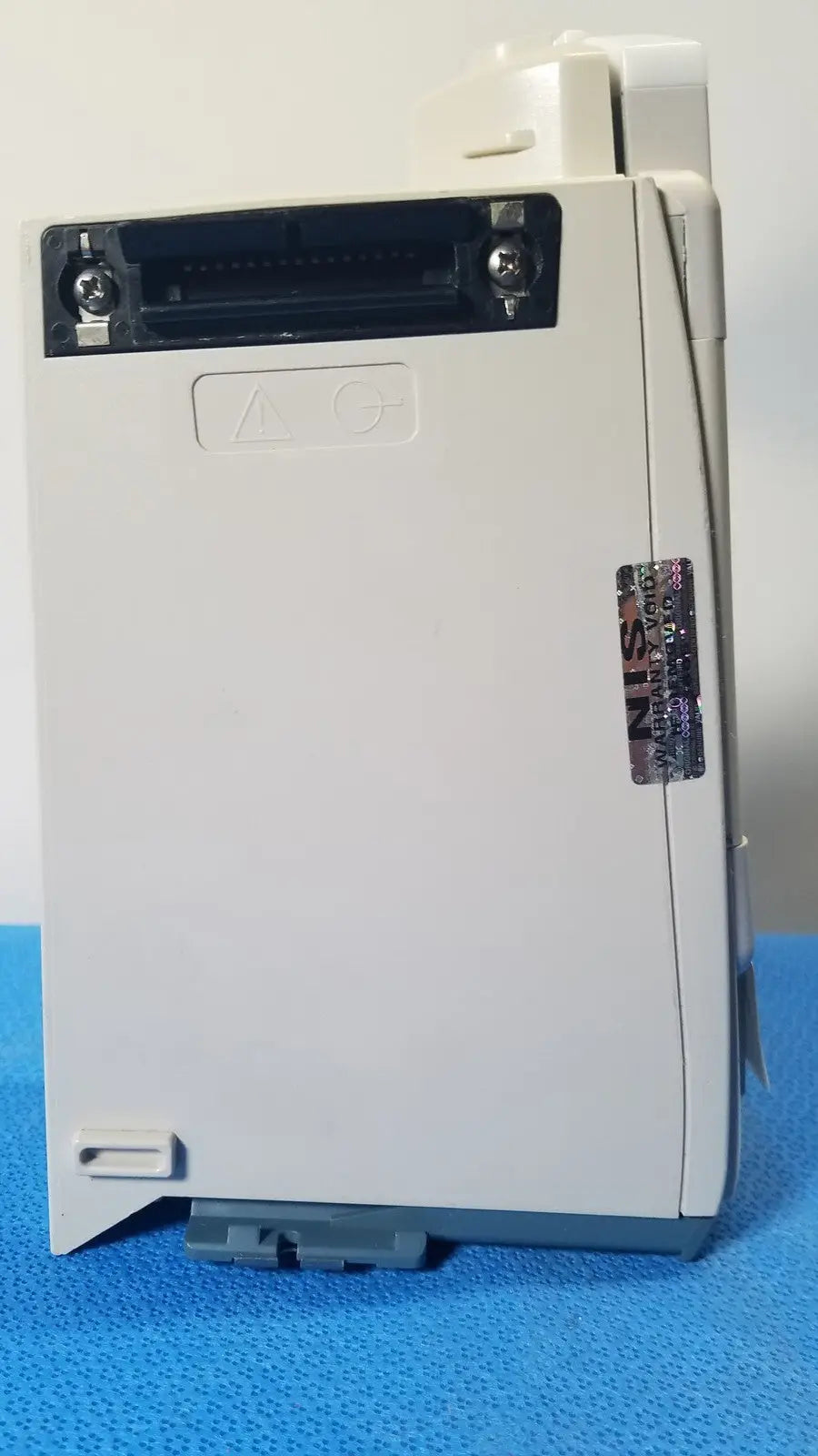 White plastic industrial control module with black connector port and gray base for cardinal health alaris pump 8100 series
