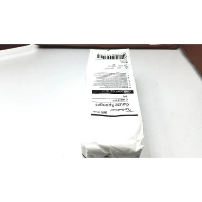 A white paper package of cardinal health curity gauze sponges 2556g containing 200 health curity gauze sponges