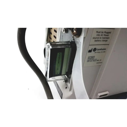 Clear plastic housing containing a green battery module in cardinal health guardrails suite pc 8015 pump for reuse medical use