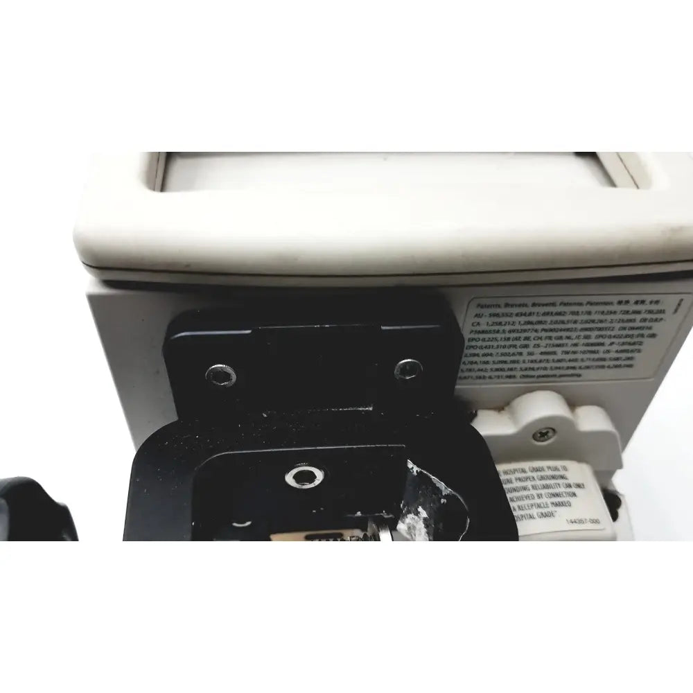 Back side of black plastic Cardinal Health PC 8015 pump with white label showing technical specs for Guardrails Suite reuse medical device