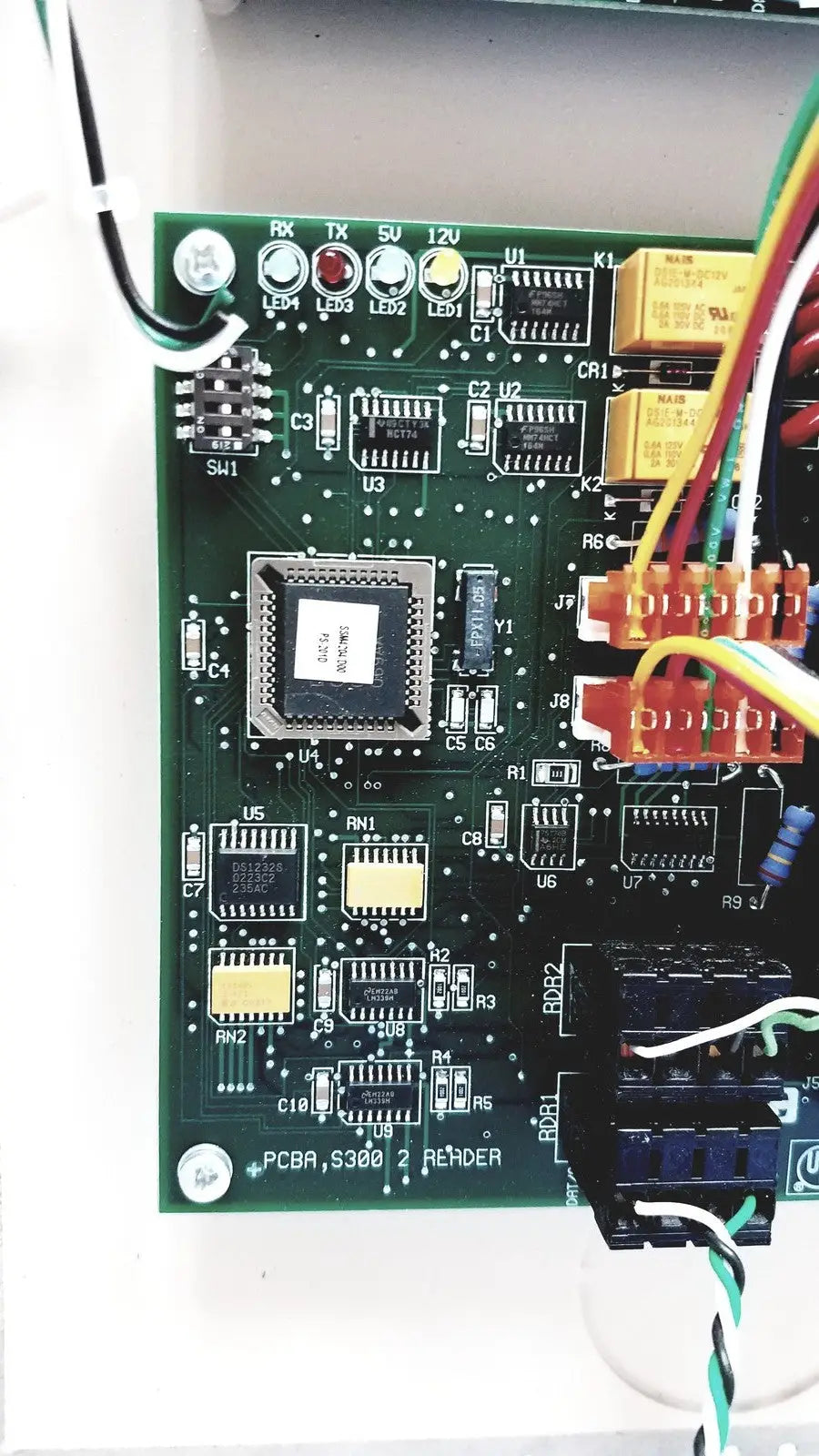 Green printed circuit board with black integrated circuit and connectors for cardkey s300-xl access control panel controller