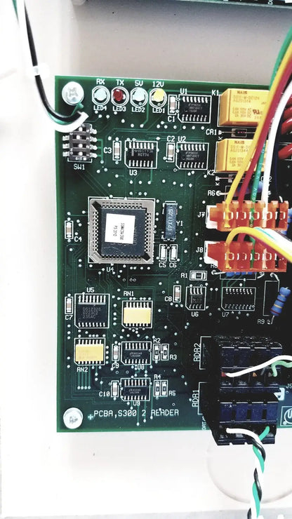 Green printed circuit board with black integrated circuit and connectors for cardkey s300-xl access control panel controller