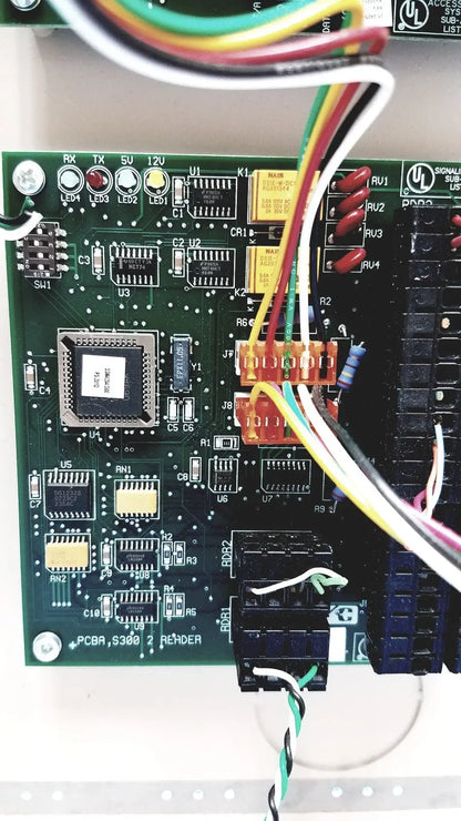 Green printed circuit board of cardkey s300-xl access control panel controller with multicolored wires connected