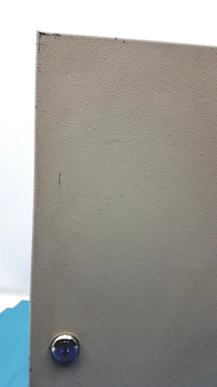 Gray textured door with circular silver keyhole for cardkey s300-xl access control panel controller