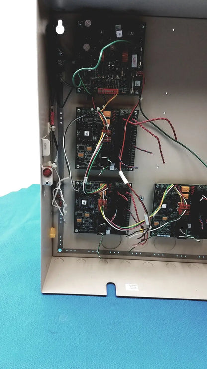 Black circuit boards with colorful wires inside metal enclosure of cardkey s300-xl access control panel controller