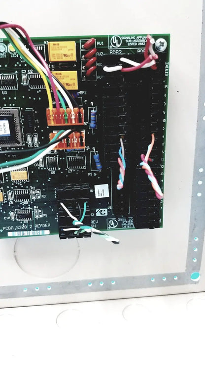 Green printed circuit board with multicolored wires of cardkey s300-xl access control panel controller