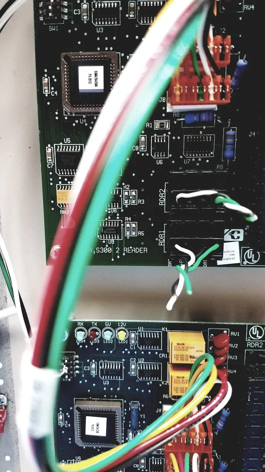 Green red and yellow wires connected to the black circuit board of the cardkey s300-xl access control panel controller