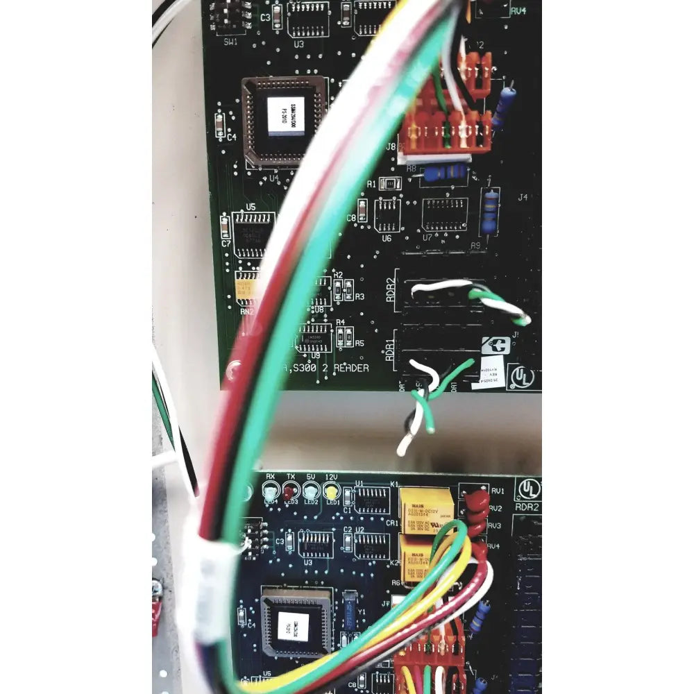 Green red and yellow wires connected to the black circuit board of the cardkey s300-xl access control panel controller