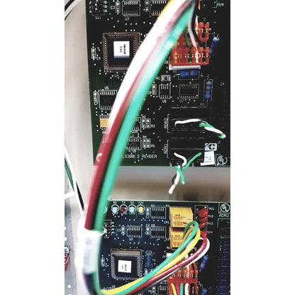 Green red and yellow wires connected to the black circuit board of the cardkey s300-xl access control panel controller