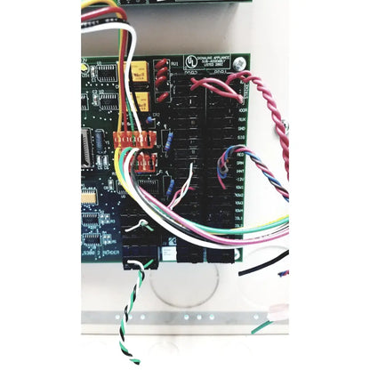 Black circuit board with colorful wires connected to orange terminal blocks on cardkey s300-xl access control panel controller