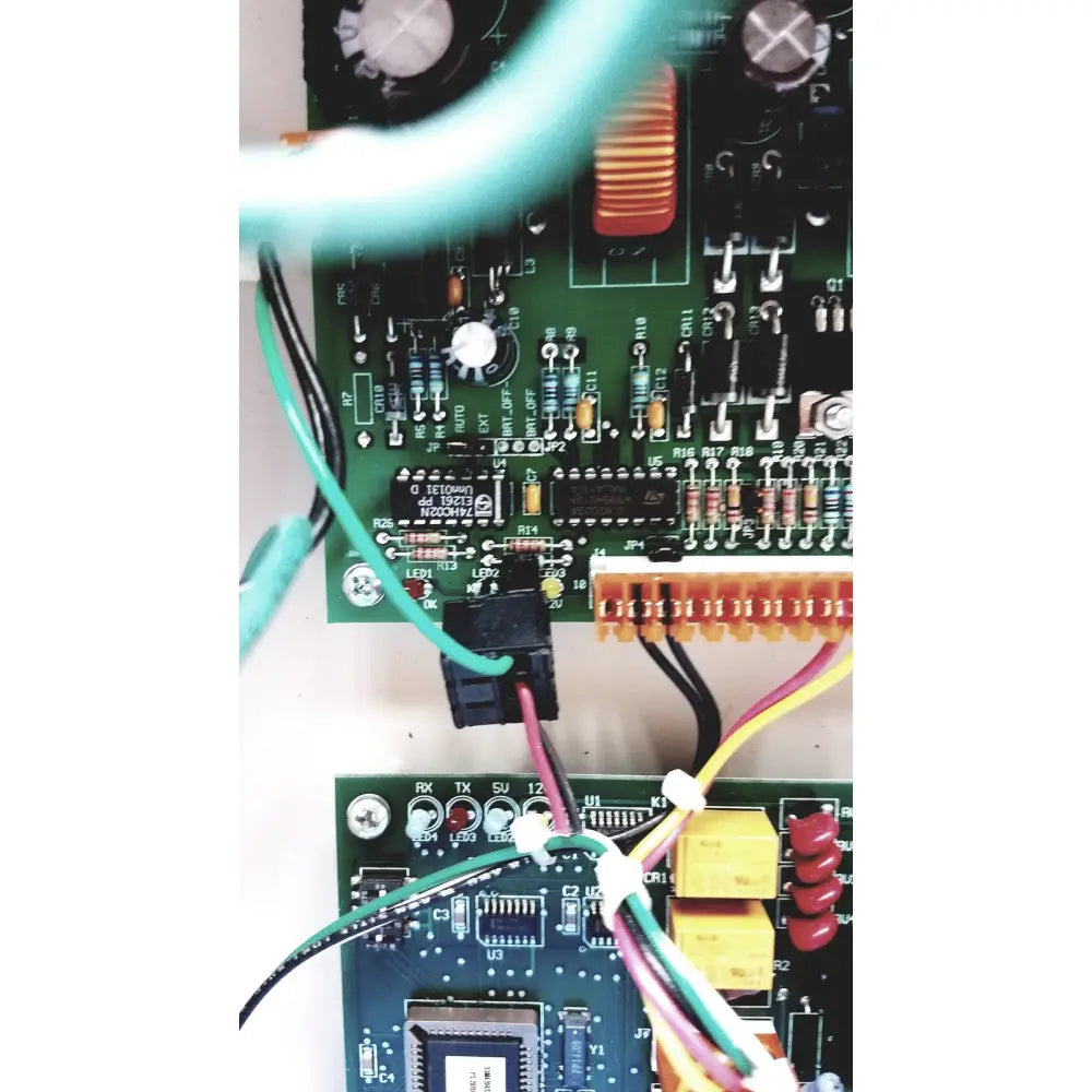 Green circuit board of the Cardkey s300-xl access control panel controller with electronic components and colored wires