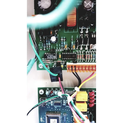 Green circuit board of the Cardkey s300-xl access control panel controller with electronic components and colored wires