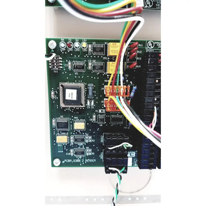 Green printed circuit board of cardkey s300-xl access control panel controller with multicolored wires connected