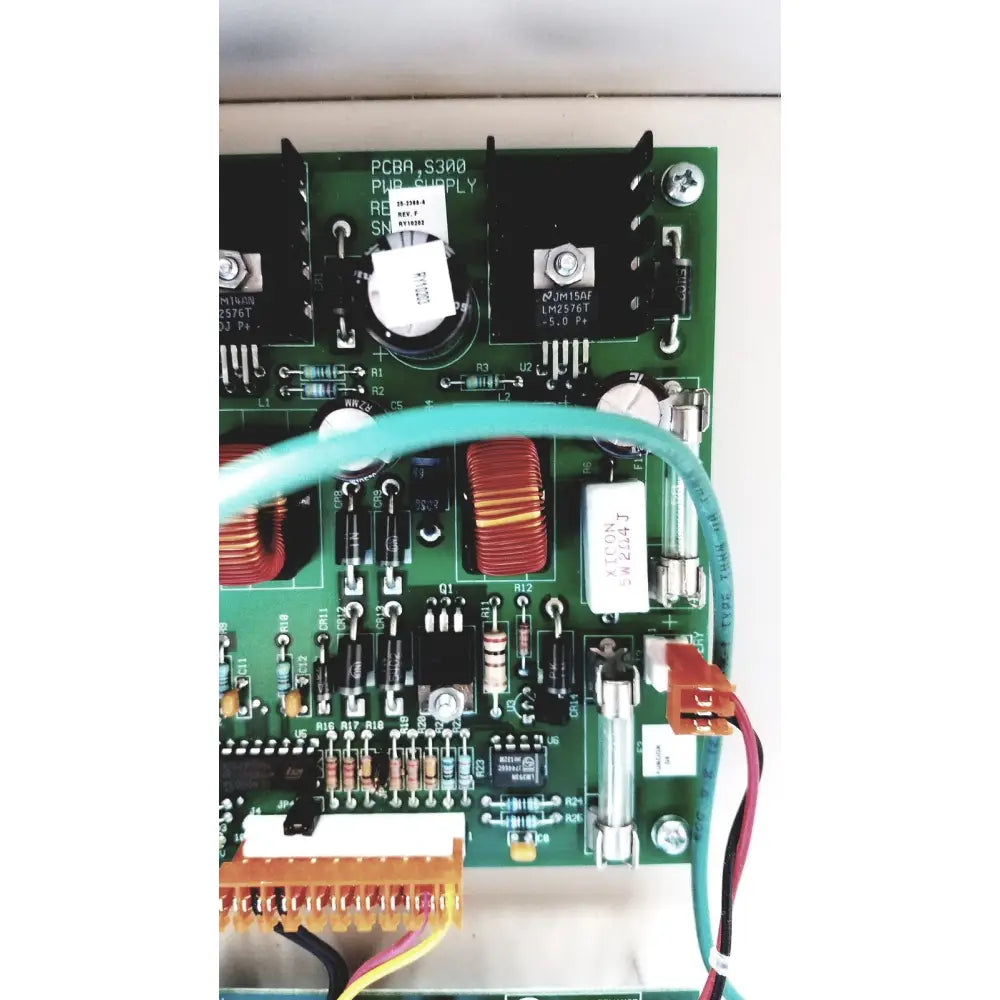 Green pcb board with electronic components and teal cable of cardkey s300-xl access control panel controller
