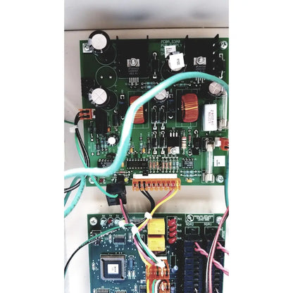 Green printed circuit board with electronic components and light blue cable in cardkey s300-xl access control panel controller