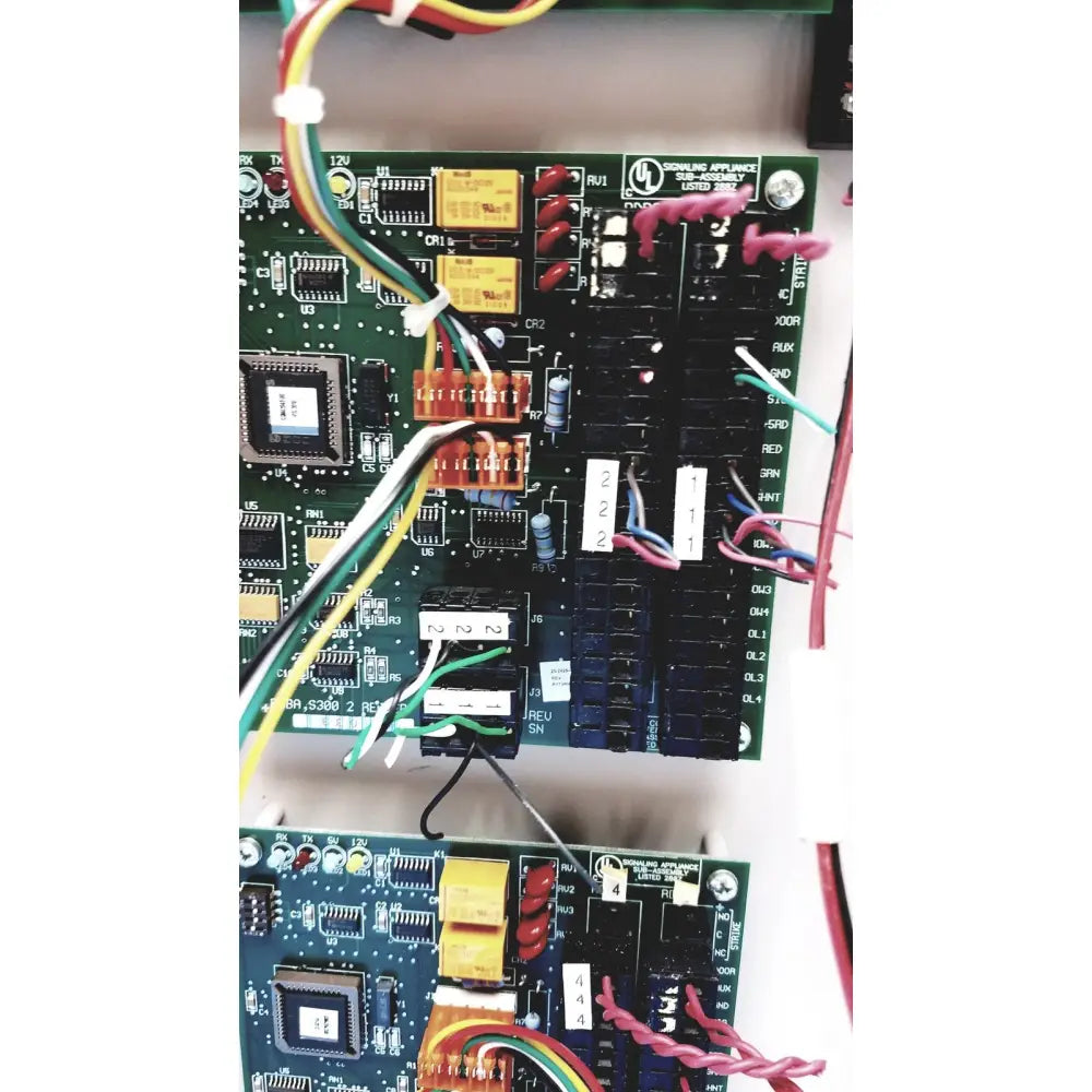 Green circuit board with electronic components and colorful wires for s300-xl access control panel controller