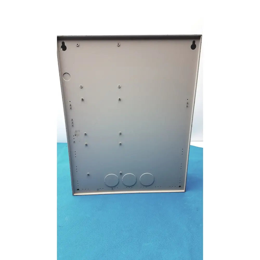 Gray metal enclosure with circular cutouts and mounting holes of cardkey s300-xl access control panel controller back side