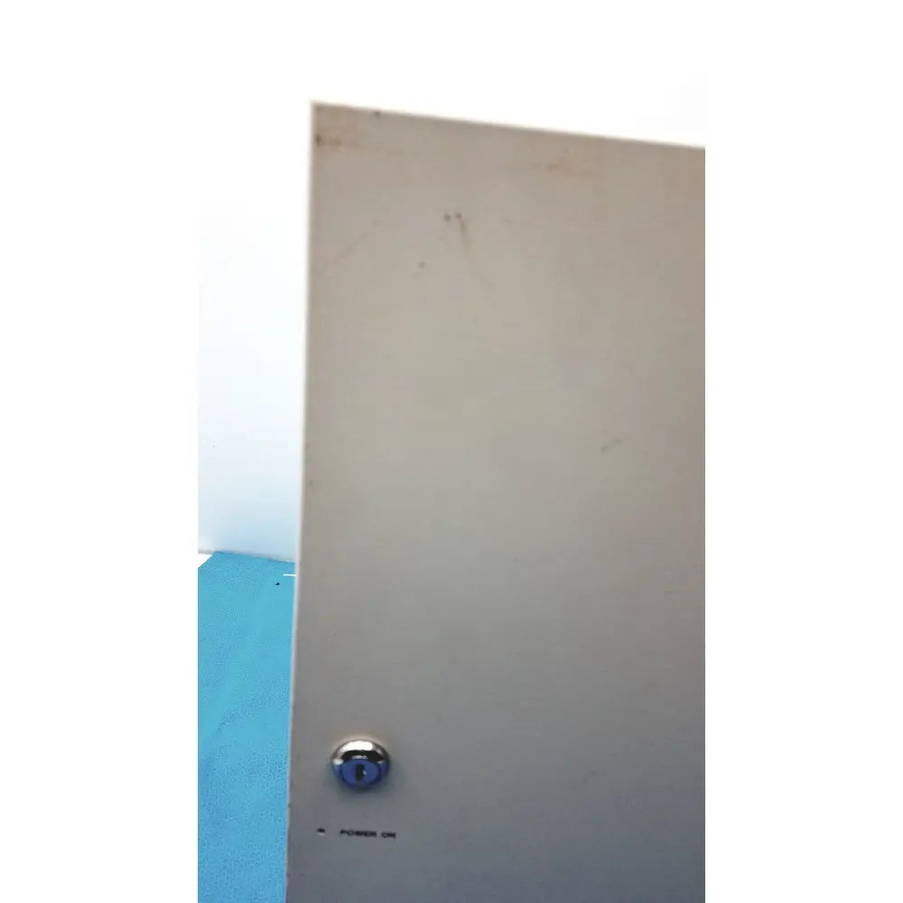 Beige metal door of s300-xl access control panel controller featuring a circular chrome lock and power on label
