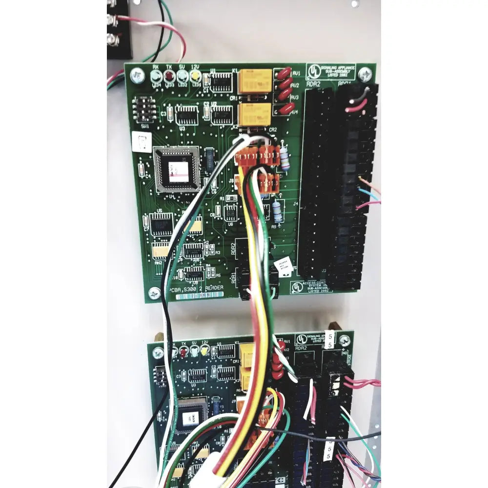 Green circuit board of cardkey s300-xl access control panel controller with colorful wiring and electronic components