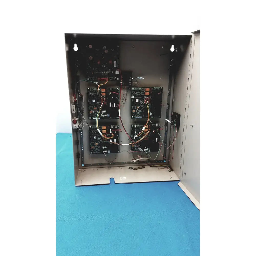 Open metal black access control panel housing multiple circuit boards and wires Cardkey S300-XL control panel controller