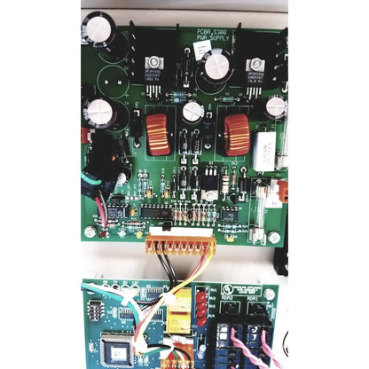 Green printed circuit board with black capacitors and red toroidal inductors in s300-xl access control panel controller