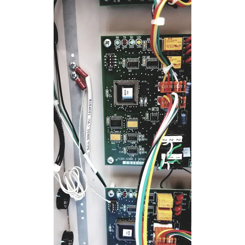 Green circuit board with pcbr 5300 microprocessor and colorful wires in s300-xl access control panel controller