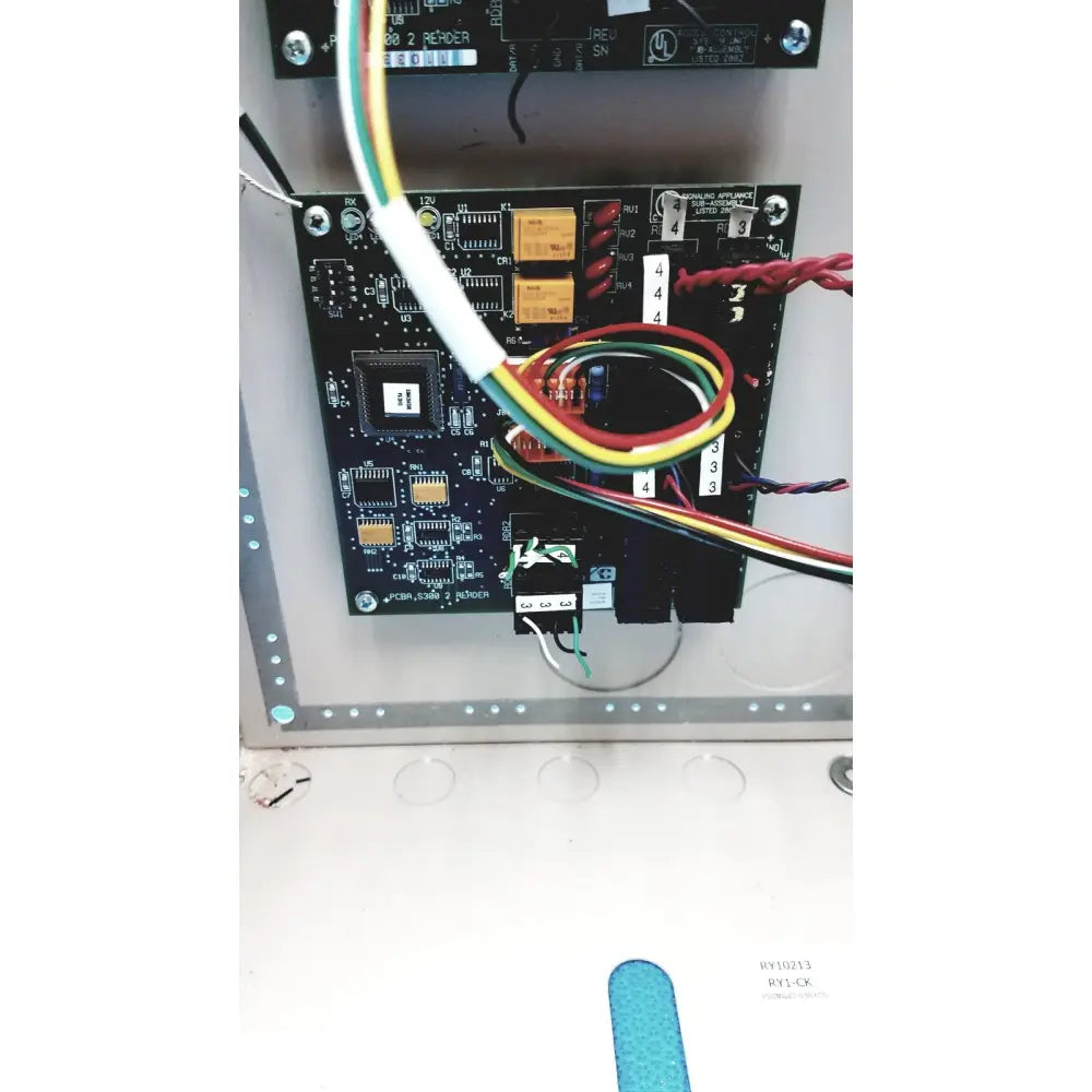 Black circuit board with yellow and red wires connected to the cardkey s300-xl access control panel controller back side
