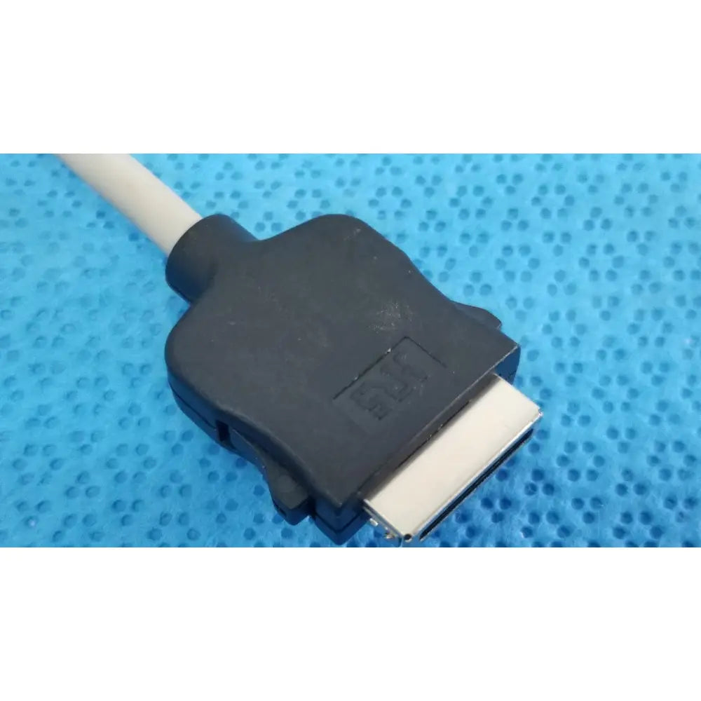 Black plastic dvi connector with silver pins attached to a white cable of carefusion coiled patient cable