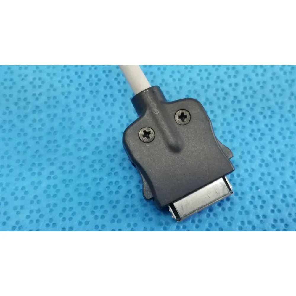 Black plastic connector with silver metallic plug and screws attached to white cable of carefusion coiled patient cable