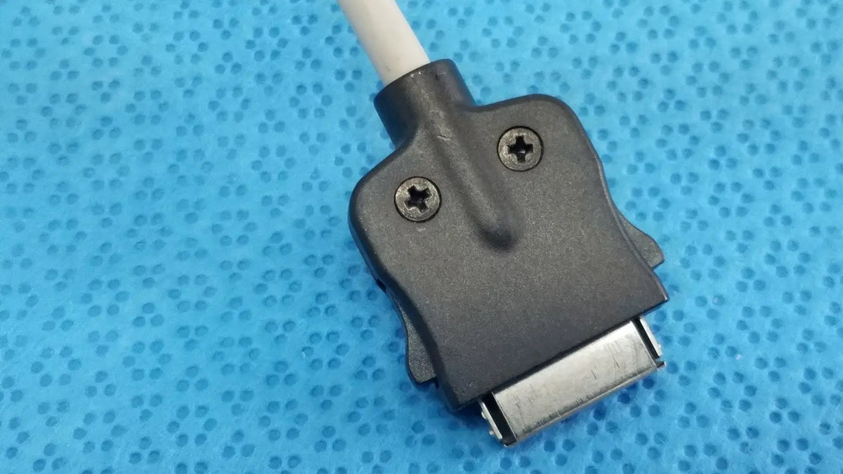 Black plastic connector with silver metallic plug and screws attached to white cable of carefusion coiled patient cable