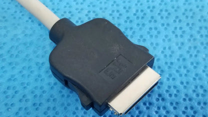 Black plastic dvi connector with silver pins attached to a white cable of carefusion coiled patient cable