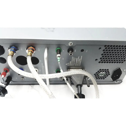 Gray audio mixer with colored input jacks and braided cables on the back of carefusion vmax encore analyzer with gas regulators