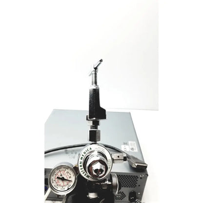 Silver and black western medical oxygen regulator with pressure gauges on carefusion vmax encore analyzer product