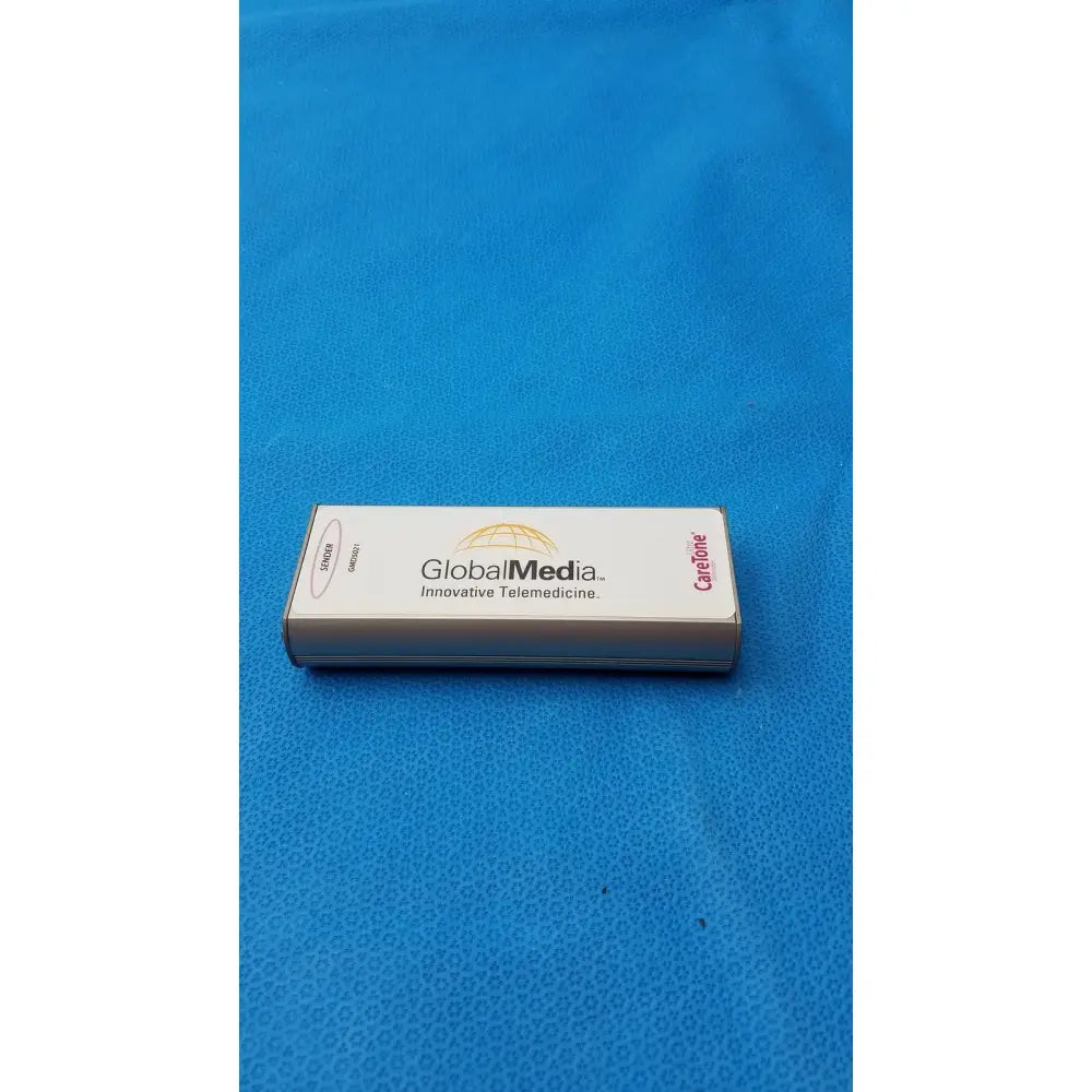 White rectangular caretone global medical innovative telemedicine sender gmd5021 with silver edges and gold globe logo