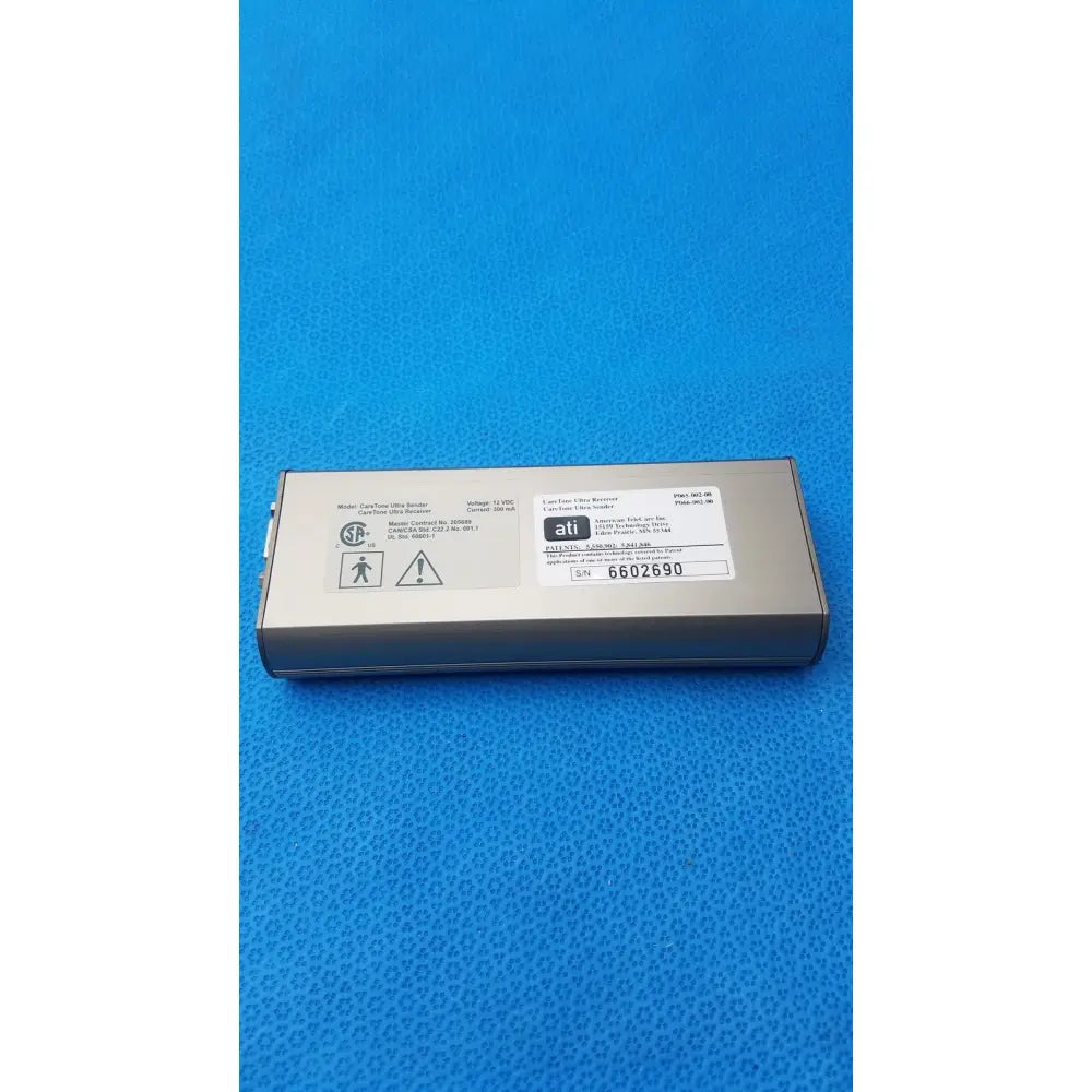 Silver rectangular ati brand power supply unit with matte finish and labels for CareTone Global Medical innovative telemedicine sender