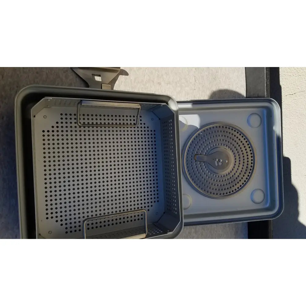 Gray plastic case medical half size sterilization tray with perforated sides and circular grated insert for medical use